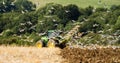 Modern John Deere tractor pulling a plough