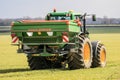 Tractor and fertilizer spreader in field