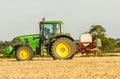 Modern john deere tractor Tractor spraying field stubble crops Royalty Free Stock Photo