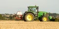 Modern john deere tractor Tractor spraying field stubble crops Royalty Free Stock Photo