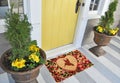 Modern Kingfisher bird printed zute doormat outside home with yellow flowers and leaves Royalty Free Stock Photo