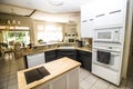 Modern Kitchen With Built-In Appliances And Granite Counter Bar Royalty Free Stock Photo