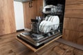 kitchen with built-in open dishwasher with clean dishes Royalty Free Stock Photo