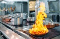 Modern kitchen. Cooks prepare meals on the stove in the kitchen of the restaurant or hotel. The fire in the kitchen. Royalty Free Stock Photo