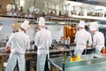 Modern kitchen. Cooks prepare meals on the stove in the kitchen of the restaurant or hotel. The fire in the kitchen. Royalty Free Stock Photo