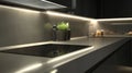 Modern Kitchen Countertop with Induction Cooktop and Under-Cabinet Lighting Royalty Free Stock Photo