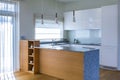 Modern kitchen design in light interior with wood accents.