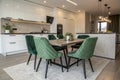 Modern kitchen and dining room with green suede chairs Royalty Free Stock Photo