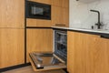 Modern kitchen with empty Built-in dishwasher with opened door, Stainless steel undermount kitchen sink and Tap water Royalty Free Stock Photo