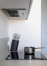 Modern kitchen extractor hood over built electric hob with stewpot Royalty Free Stock Photo