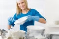 Modern kitchen - happy woman washing dishes Royalty Free Stock Photo