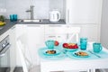 Modern kitchen interior and breakfast. White kitchen and turquoise accessories Royalty Free Stock Photo