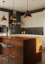 Modern Kitchen Interior Design with Rust Island and Copper Lighting Royalty Free Stock Photo