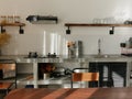 Modern kitchen interior with dining table with retro decor elements, vintage fixtures, stylish interior, concrete and