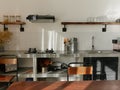 Modern kitchen interior with dining table with retro decor elements, vintage fixtures, stylish interior, concrete and