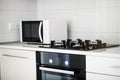 Modern kitchen interior with electric and microwave oven. Royalty Free Stock Photo