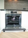 Modern kitchen interior with electric oven, electic stove in light blur.