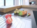 Modern kitchen interior with fresh vegetables on stone counter top Royalty Free Stock Photo