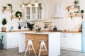 Modern Kitchen Interior with Island, Sink, Cabinets in New Luxury Home Decorated in Christmas Style. Royalty Free Stock Photo