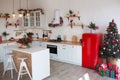 Modern Kitchen Interior with Island, Sink, Cabinets in New Luxury Home Decorated in Christmas Style. Royalty Free Stock Photo