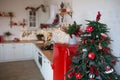 Modern Kitchen Interior with Island, Sink, Cabinets in New Luxury Home Decorated in Christmas Style.