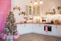 Modern Kitchen Interior with Island, Sink, Cabinets in New Luxury Home Decorated in Christmas Style. Royalty Free Stock Photo