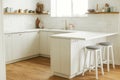 Modern kitchen interior. Stylish white kitchen cabinets with brass knobs, granite island, appliances and utensils on wooden Royalty Free Stock Photo