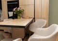 Modern kitchen interior with wooden table and chairs Royalty Free Stock Photo