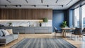 Modern kitchen and living room interior with grey sofa, dining table, and wood paneling Royalty Free Stock Photo