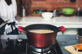 Modern kitchen with a red pot with boiling water Royalty Free Stock Photo