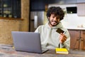 In a modern kitchen a relaxed man participates in an online payment process Royalty Free Stock Photo