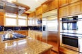 Modern kitchen room interior with wooden cabinets, granite count