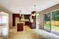 Modern kitchen room with matte brown cabinets and exit to backyard