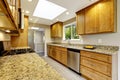 Modern kitchen room with matte brown cabinets, shiny granite tops