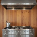 Modern kitchen setup featuring a stainless steel gas range with multiple burners and Royalty Free Stock Photo
