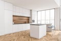 Modern kitchen with simple white cabinets and wood floor. Corner view Royalty Free Stock Photo