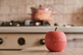 Modern kitchen timer apple shaped on the background of the kitchen Royalty Free Stock Photo