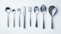 Shiny Metal Kitchen Utensils Set on White Background - Spoons, Forks, Knife, Slotted Spoon Royalty Free Stock Photo
