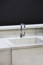 Modern kitchen, the water tap and concrete kitchen sink.  Concrete kitchen with a tap and gray worktop Royalty Free Stock Photo
