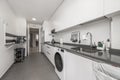 Modern kitchen with white cabinets combined with black stone countertop Royalty Free Stock Photo