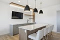 Modern kitchen with a white counter and black and white lights Royalty Free Stock Photo