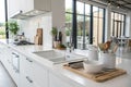 Modern kitchen with white counters and sink Royalty Free Stock Photo