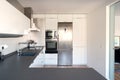 Modern kitchen with white cupboards and black countertop