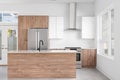 A modern kitchen with wood and white cabinets. Royalty Free Stock Photo