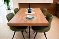 Modern kitchen, wooden walnut dining table and green chairs