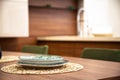 Modern kitchen, wooden walnut dining table and plates