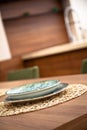 Modern kitchen, wooden walnut dining table and plates