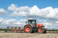 Modern Kubota tractor pulling a plough Royalty Free Stock Photo