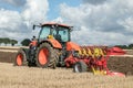 Modern Kubota tractor pulling a plough Royalty Free Stock Photo