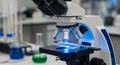 Modern Laboratory Microscope with Blue Light Illuminating Slide in Scientific Research Setting Royalty Free Stock Photo